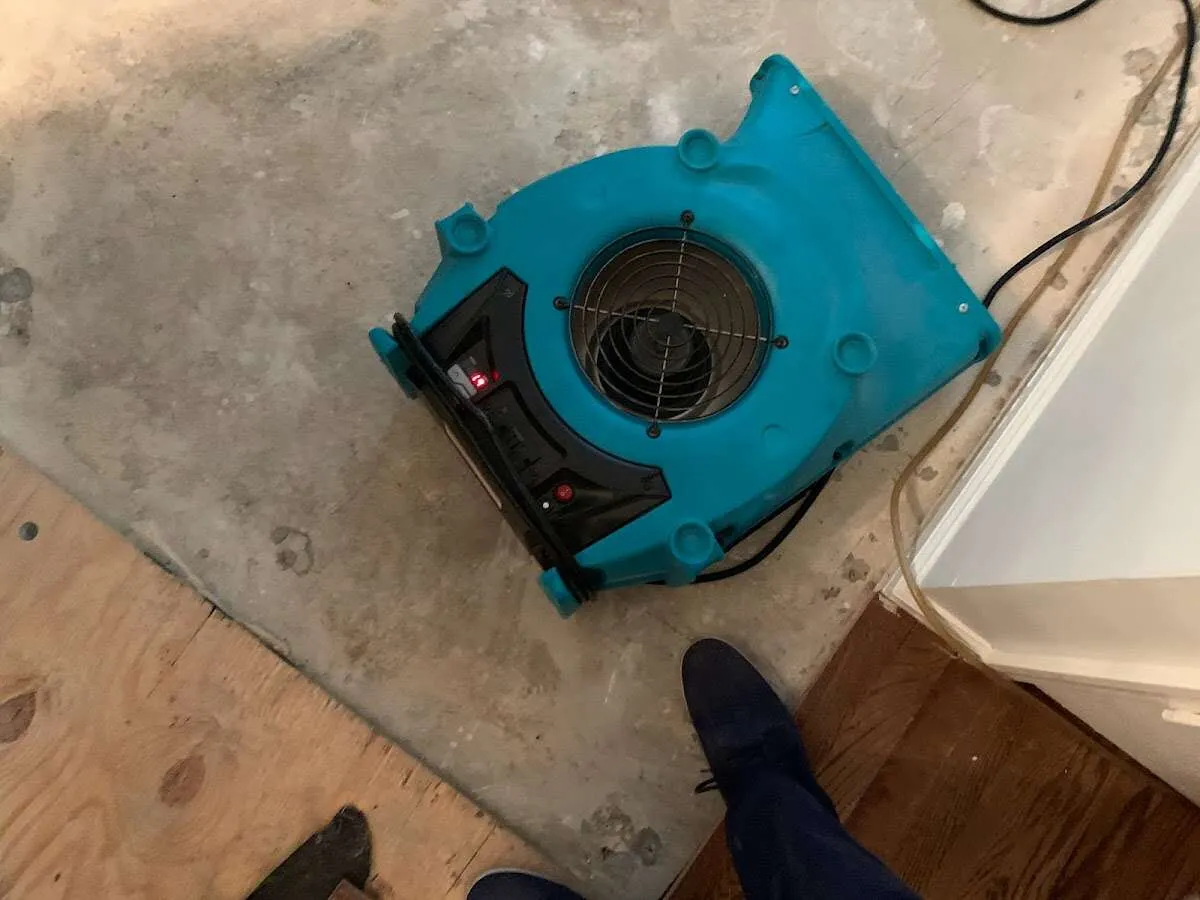 Air mover drying subfloor during Commercial Water Damage Restoration in La Cresta